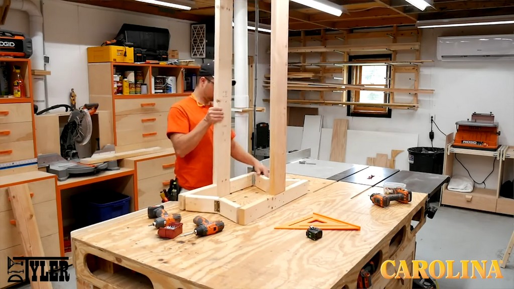 man testing movement of DIY woodworking build