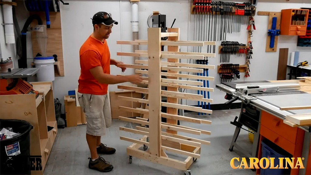 man demonstrating completed woodworking build