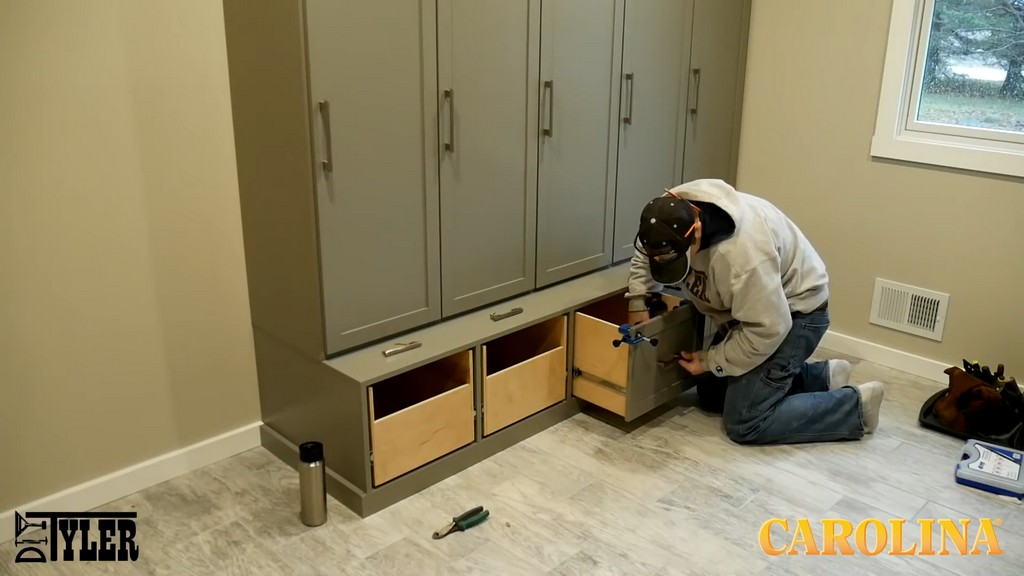 man finishing up set of wooden lockers